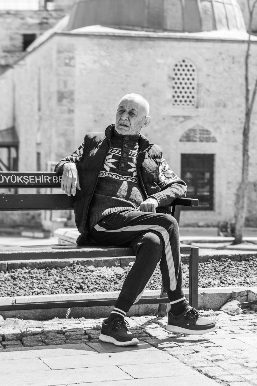elderly man talking on bench