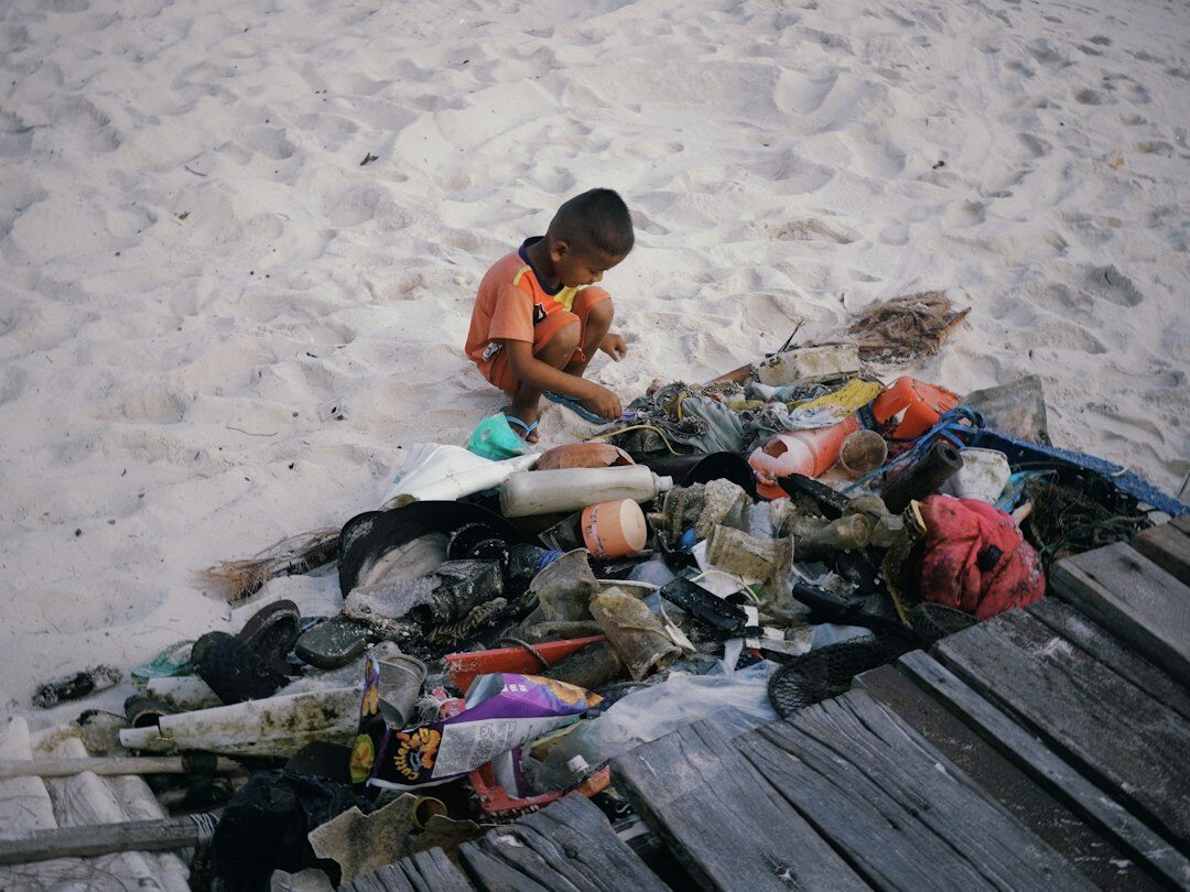 fisherman mending nets on shore