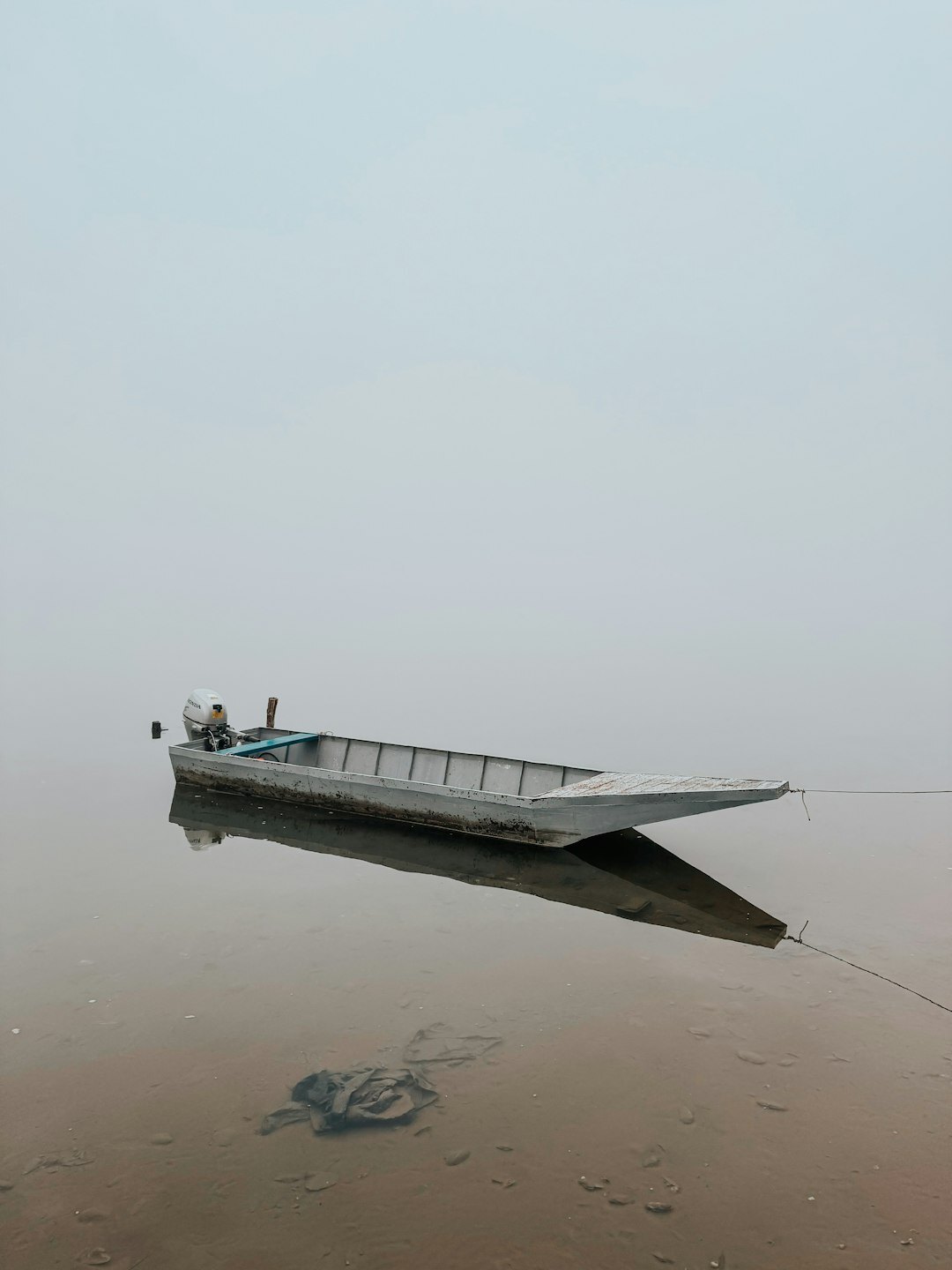 fisherman on boat in fog