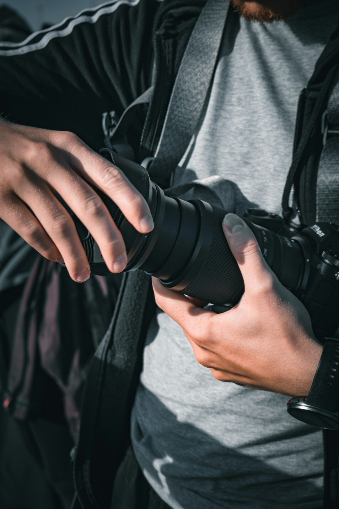 Portrait of a Scandinavian male documentary photographer in his 30s holding a camera