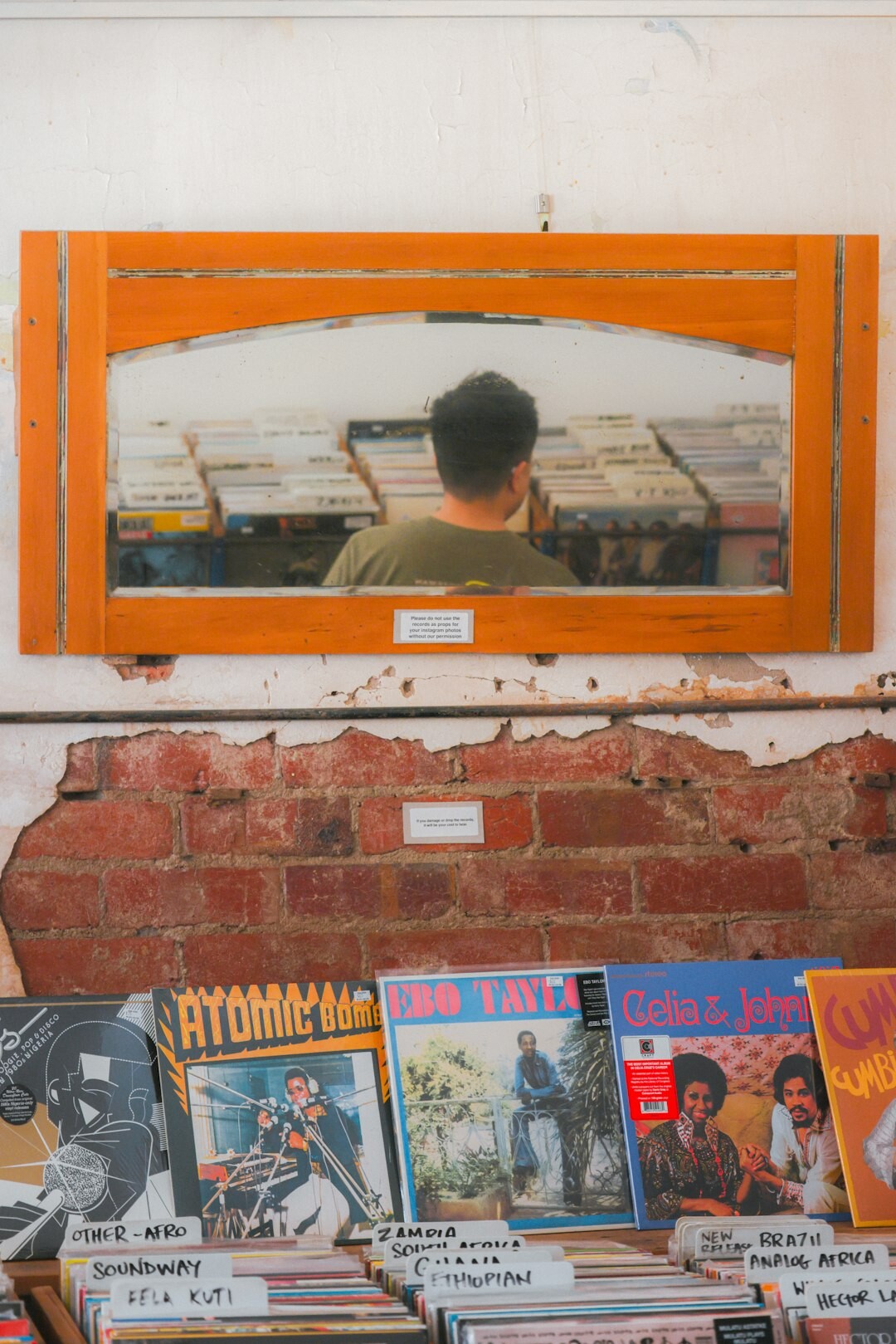 Editor reviewing printed photographs and negatives on a light table in an archive room