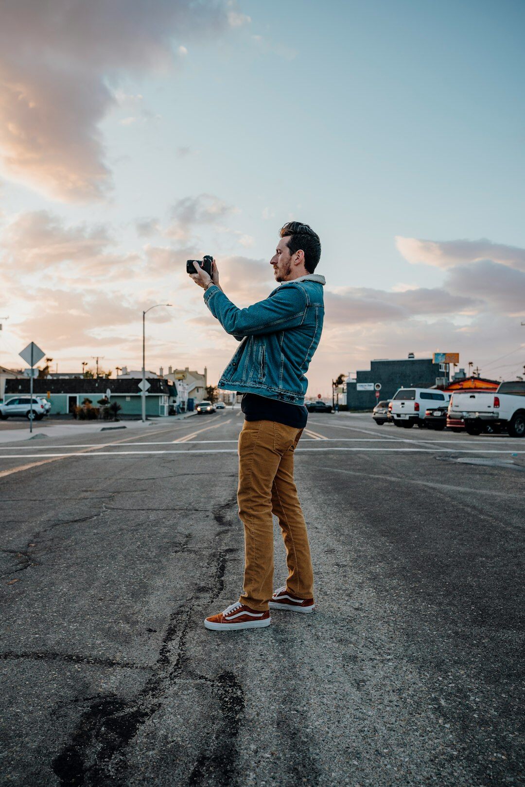 young man with camera in street